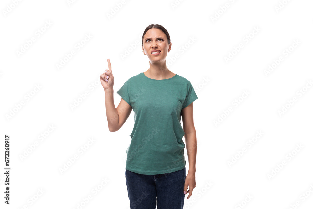 A 30 year old positive European brunette woman with a ponytail is dressed in a green T-shirt and jeans talks about advertising A 30 year old positive European brunette woman with a ponytail is dressed in a green T-shirt and jeans talks about advertising