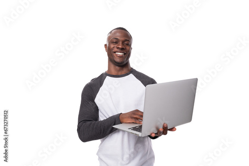 young african man working remotely in the field of IT and using a laptop