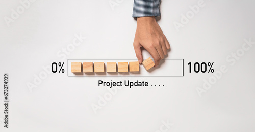 Quadro su tela Hand arrange wooden block cube download bar from 0% to 100% for project update progress concept