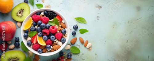 Top view of colorful fruit mix with nuts in a bowl. Healthy breakfast concept. Fresh fruit, raw food photo