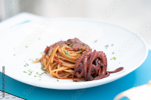 Spaghetti di Gragnano alla Luciana (with real octopus), bronze drawn pasta from Gragnano, spaghetti with octopus and piennolo tomatoes photo