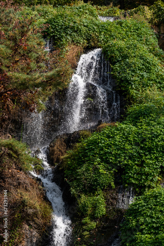 Close-up of waterfall with autumn foliage