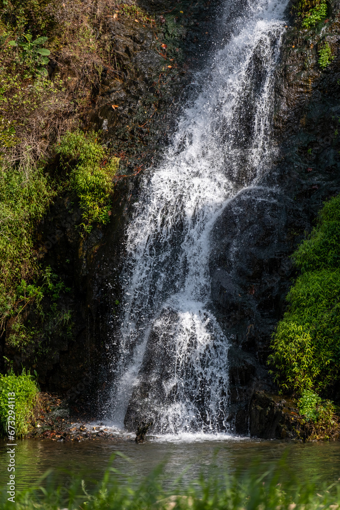 Fototapeta premium Close-up of waterfall with autumn foliage