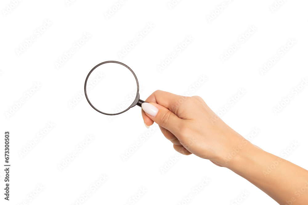 An elegant female hand with a beautiful manicure holds a magnifying glass. Mockup or template with round empty space for text and design, isolated on white background. An elegant female hand with a beautiful manicure holds a magnifying glass. Mockup or template with round empty space for text and design, isolated on white background.