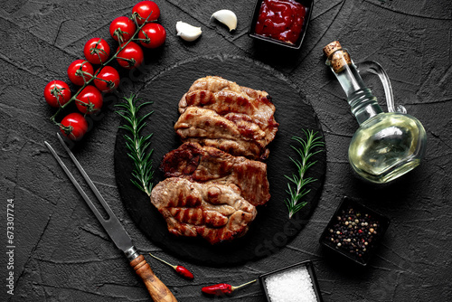 grilled pork steaks on stone background