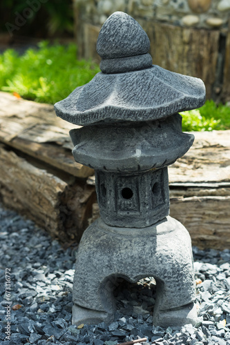Ancient Japanese stone grey lantern in park.