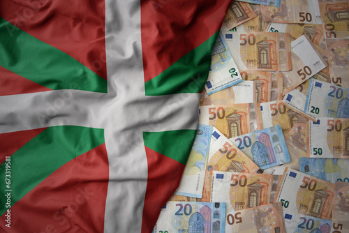 colorful waving national flag of basque country on a euro money background. finance concept