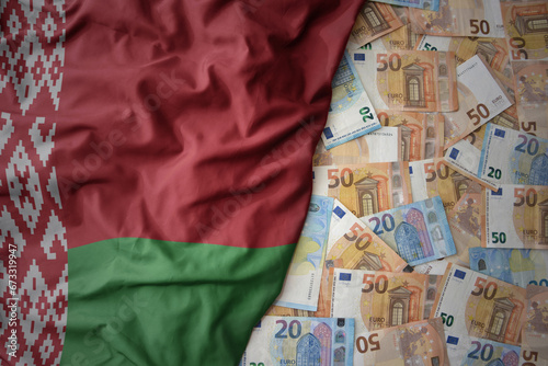 colorful waving national flag of belarus on a euro money background. finance concept