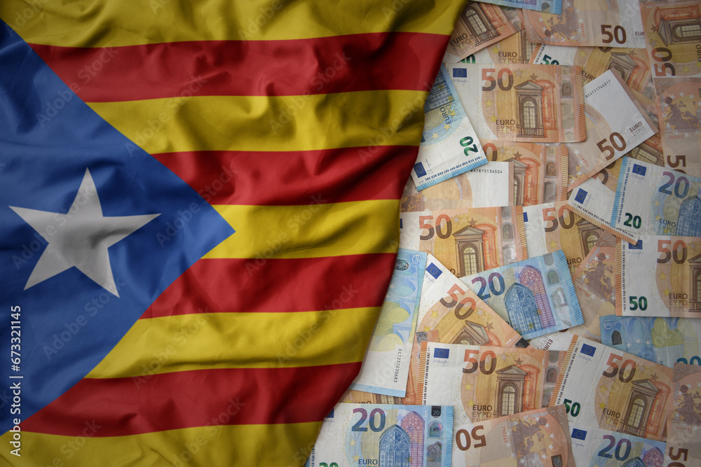 colorful waving national flag of catalonia on a euro money background. finance concept colorful waving national flag of catalonia on a euro money background. finance concept