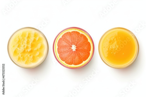 Fresh orange carrot and grapefruit juices in glasses isolated on a white background viewed from the top