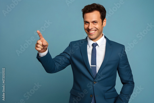 Cheerful Businessman Pointing to Copy Space for Advertising. Blue Background