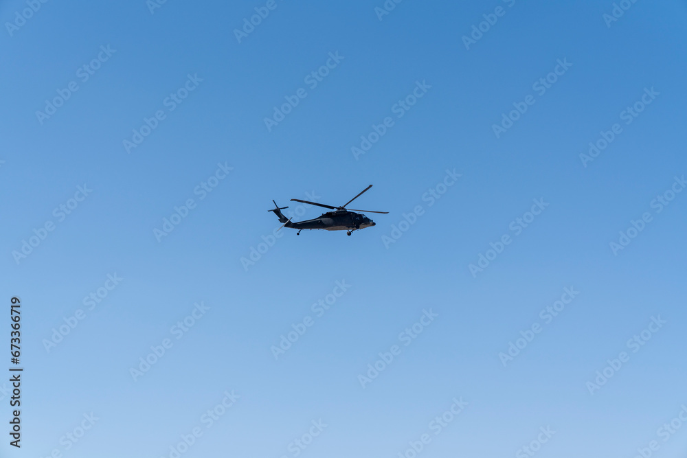 A military Sikorsky helicopter flies in the sky A military Sikorsky helicopter flies in the sky