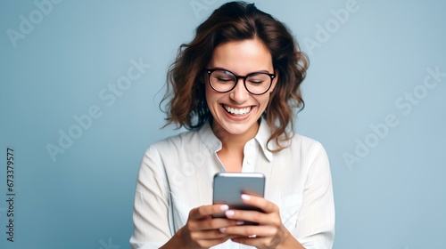 beautiful female entrepreneur wearing eyeglasses and reading good news over smart phone over blue background. generative AI