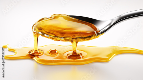 Isolated oil drops of honey  serum  or cooking oil on a white surface.