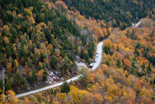 Photo of Cars going down a highway in autumn