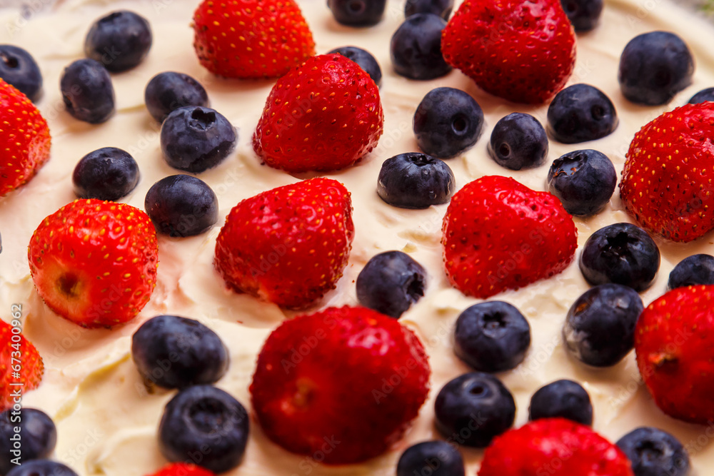 Fresh juicy red strawberries and blueberries in heavy whipped cream close-up. Fresh juicy red strawberries and blueberries in heavy whipped cream close-up.