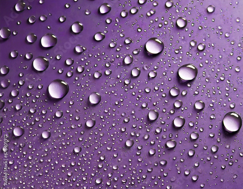 Close-up of water drops on purple surface, abstract background