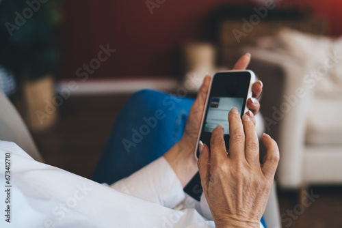 Unrecognizable woman reading text message in smartphone