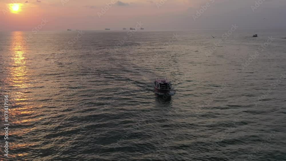 Aerial video of a small boat leaving the port of the old city of Acre, Israel Aerial video of a small boat leaving the port of the old city of Acre, Israel