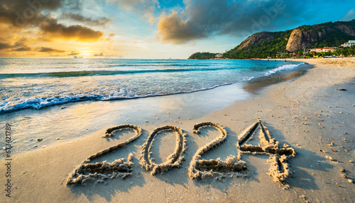 escrito en la arena de playa con el nuevo año 2024 photo