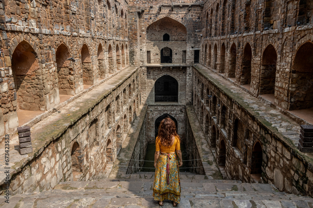 Woman at historic stepwell Agrasen Ki Baoli in Delhi India. 108 steps