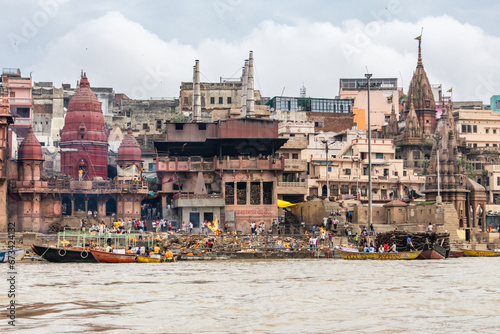 View of the river Ganges with its boats, people and sacred water of Varanasi in India. Manikarnika Ghat photo