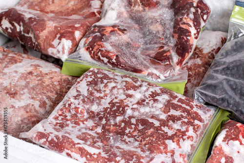 Raw frozen meat. Frozen food. Raw pork chops in the freezer. photo