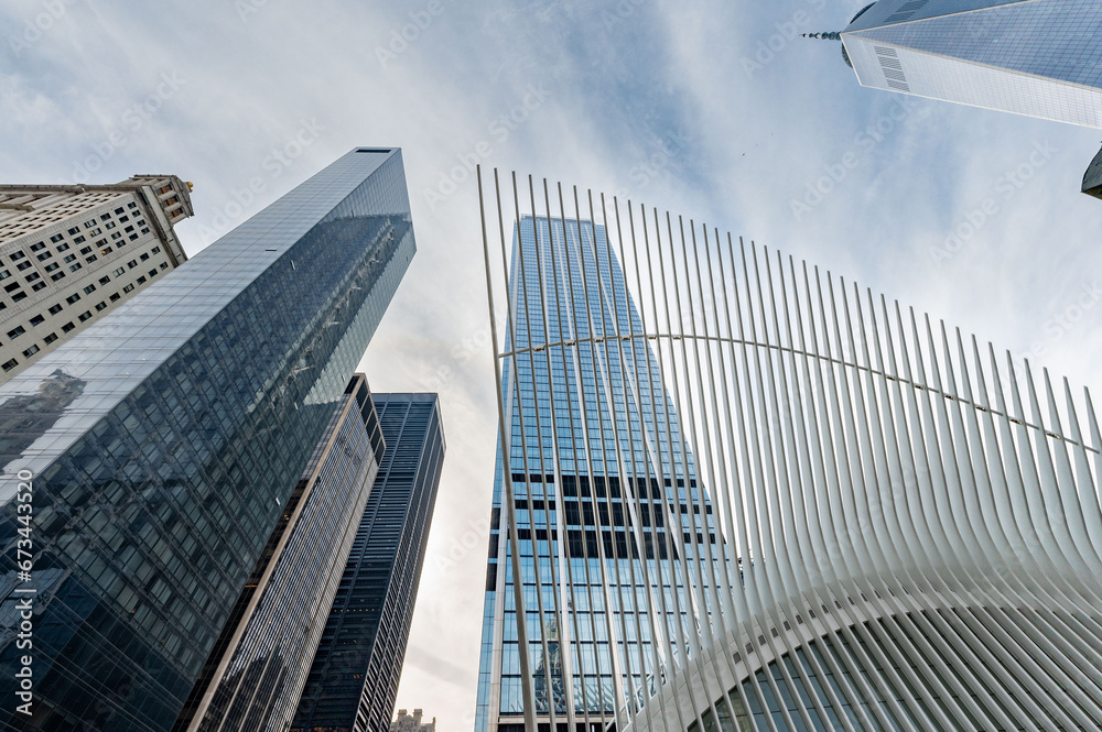 View from the bustling streets of Lower Manhattan, showcasing an iconic tower soaring into the cloud