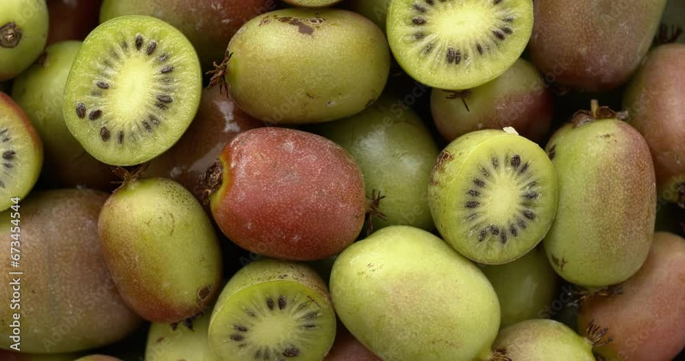 Hardy kiwi fruit (mini kiwi) background. Table spin. 