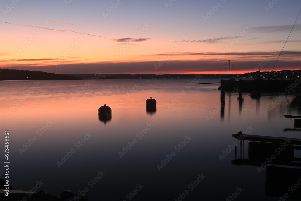 sunrise over calm water - Lysaker