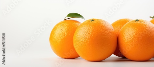 An orange fruit stands alone on a white surface