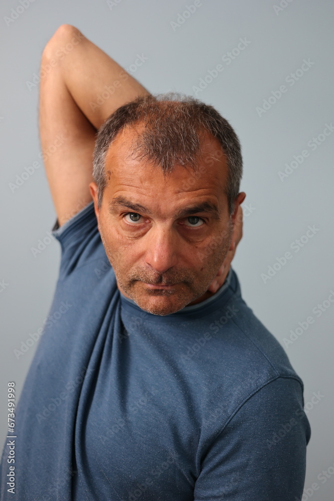Fototapeta premium Middle aged, mature male stretching his right arm