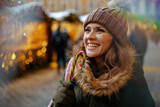 smiling young woman at winter fair in city