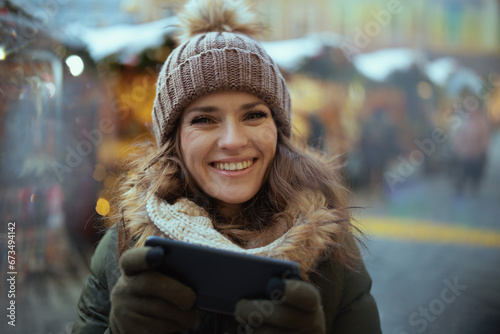 Photography smiling young female at christmas fair in city