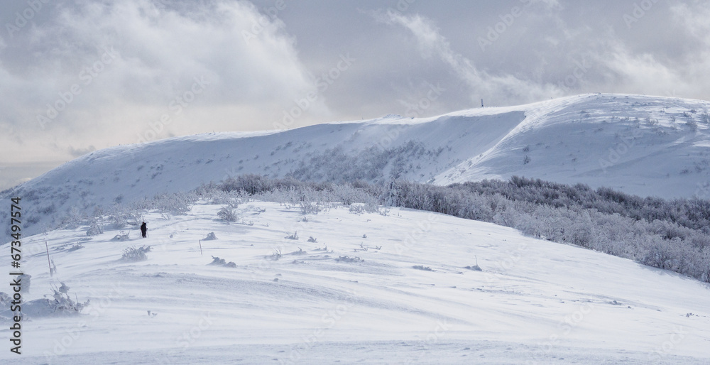 Winter mountain landscape. Mountain peaks covered with snow. View from Mala Rawka to Wielka Rawka. Bieszczady Mountains. Poland Winter mountain landscape. Mountain peaks covered with snow. View from Mala Rawka to Wielka Rawka. Bieszczady Mountains. Poland