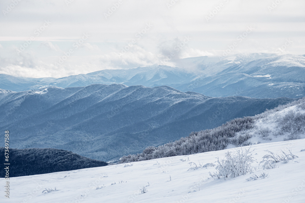 Winter mountain landscape. Mountain peaks covered with snow. View from Mala Rawka . Bieszczady Mountains. Poland