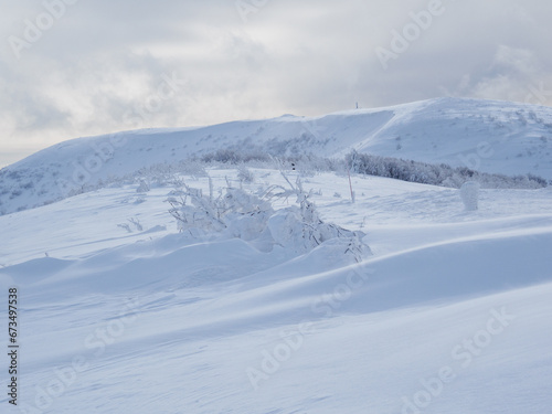 Fototapeta Naklejka Na Ścianę i Meble -  Winter mountain landscape. Mountain peaks covered with snow. View from Mala Rawka to Wielka Rawka. Bieszczady Mountains. Poland
