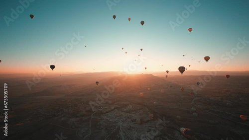 Hot air balloons flight the early morning. Cappadocia is one of the most well known tourist destination. You can visit the fairy chimneys and ride a hot air balloon during the sunrise. photo