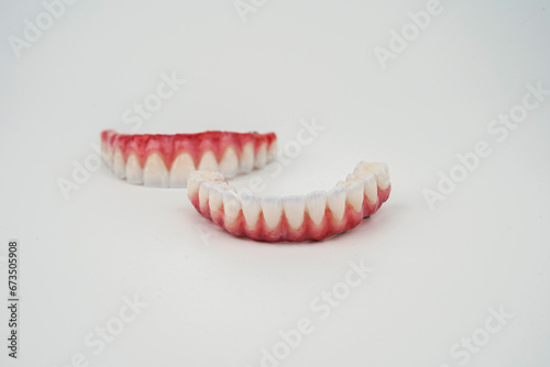 Excellent composition of upper jaw and lower jaw prostheses on a white background