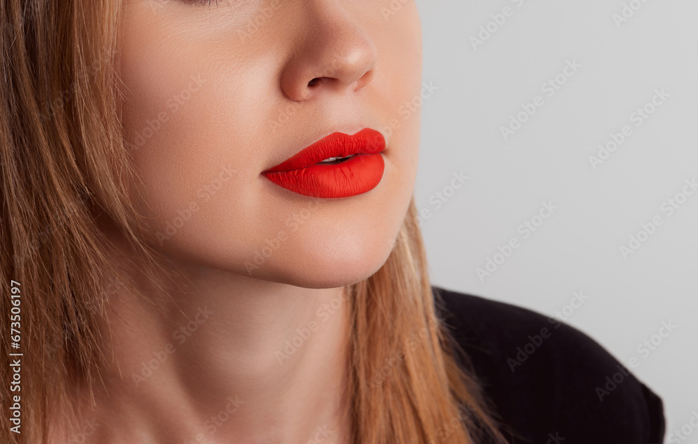 Close up female plump lips with red matte lipstick. Beauty fashion portrait personal care and make up Close up female plump lips with red matte lipstick. Beauty fashion portrait personal care and make up