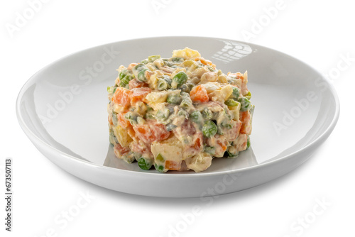 Russian salad in white plate, typical Piedmontese salad Italy made with pieces of vegetables with mayonnaise sauce.