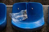 Seat in a football stadium in the Balkans with discarded sunflower seeds