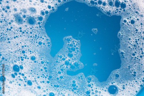 Obraz na płótnie Detergent foam bubble on wate. Blue background, Soap sud