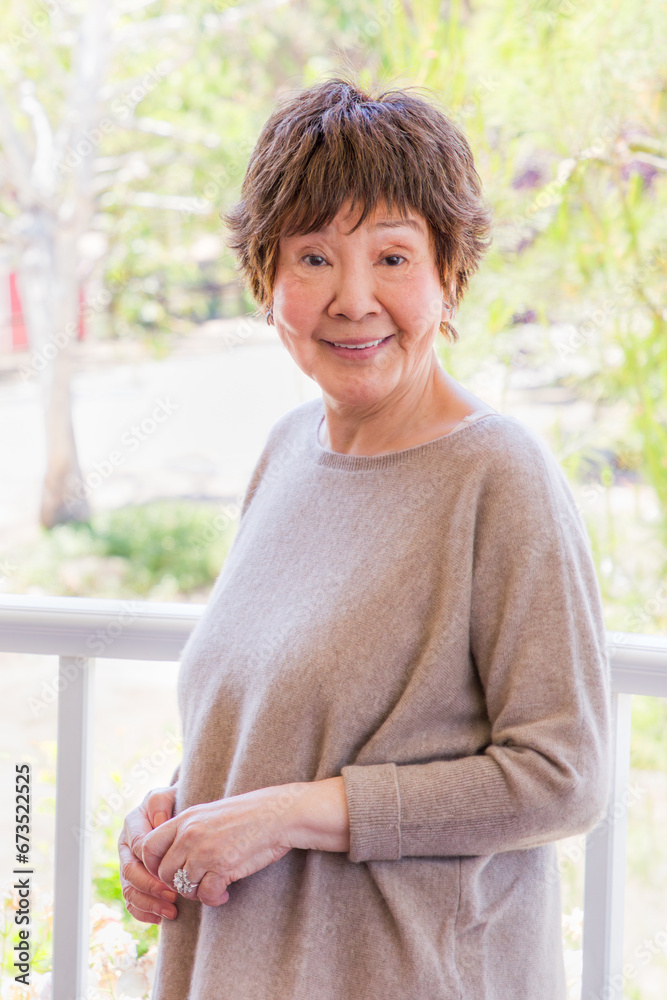 Fototapeta premium Happy Senior Chinese Woman Poses for Her Portrait Outdoors.