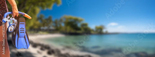Woman Holding Snorkeling Gear on a Sunny Tropical Shoreline.. photo
