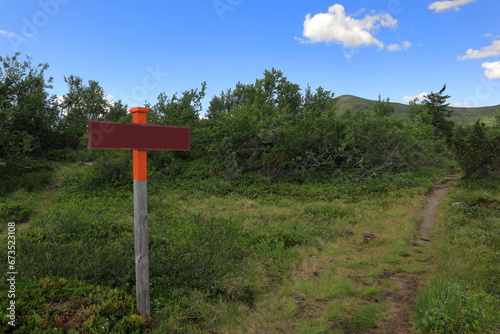Blank red sign for your design. Green nature. Copy space. Summer in July. Ansätten, Jämtland, Sweden.