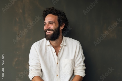 Portrait of a handsome man with beard and mustache smiling at the camera