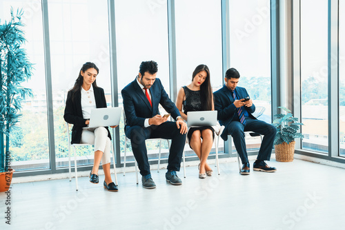 Job seekers and applicants waiting for interview on chairs in office. Job application and recruitment interview qualification concept. Jivy © Summit Art Creations