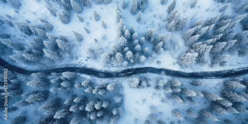 Aerial top view of frozen road in snowy winter woods. Landscape of forest with path, snow and trees. Concept of nature, travel, Siberia, Norway, country, season, flight