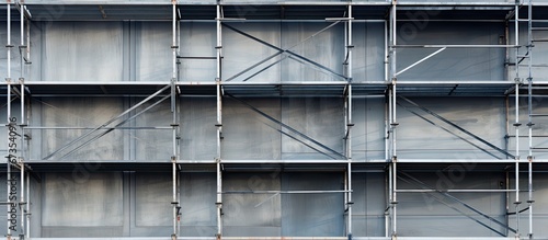 Thoroughly assembling scaffolding for an industrial structure Background design featuring steel and metal bars